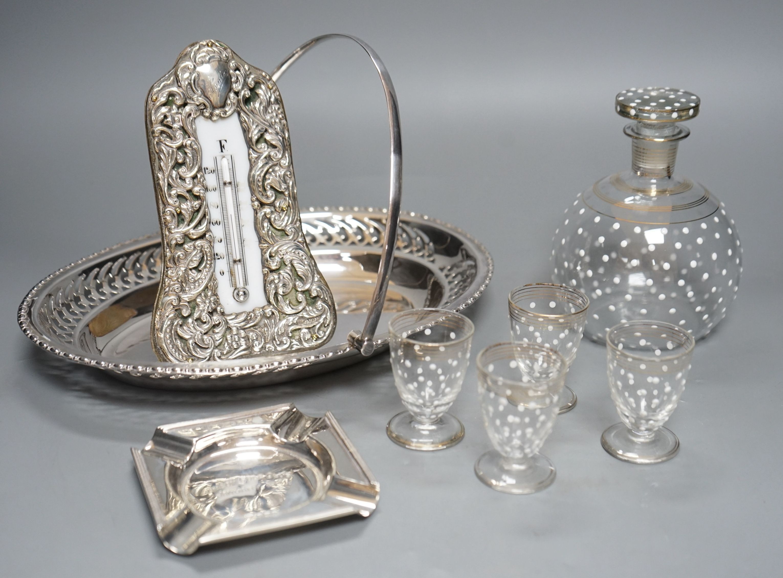 A silver-mounted Victorian thermometer, silver ashtray, plated basket stand, a small enamelled decanter and 4 matching glasses, thermometer 17.5cms high